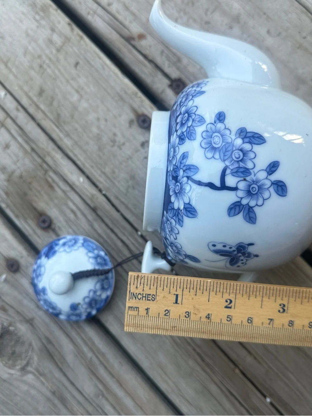 Blue and white floral teapot with butterfly design